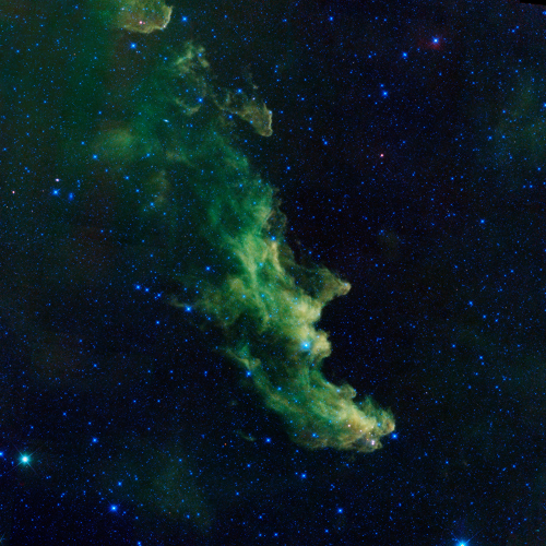 A green nebula cloud against a starry background resembling the side profile of a witch face.