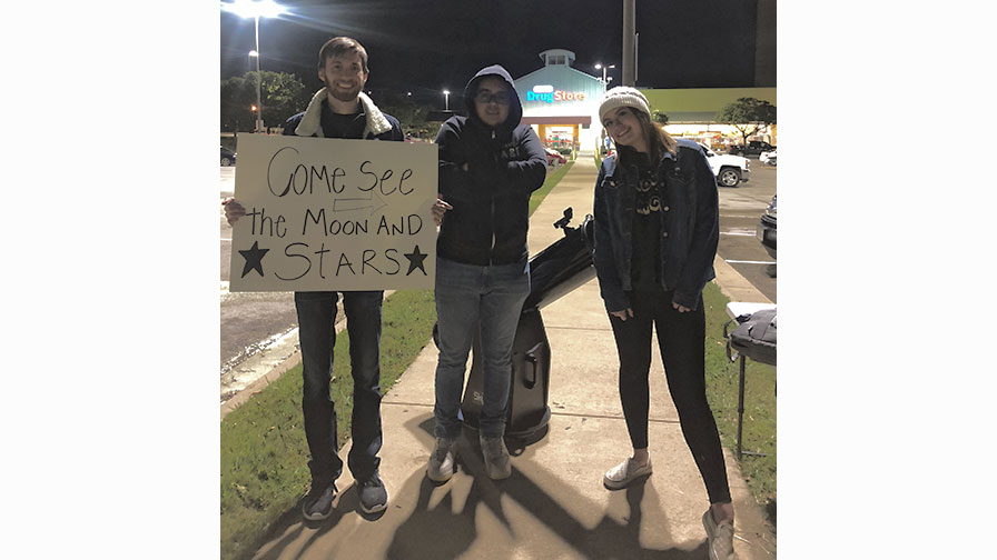 photo of three young people inviting you to come stargaze